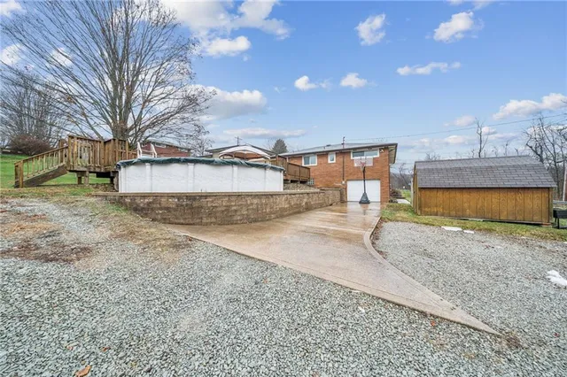 an aerial view of a residential houses with outdoor space and swimming pool