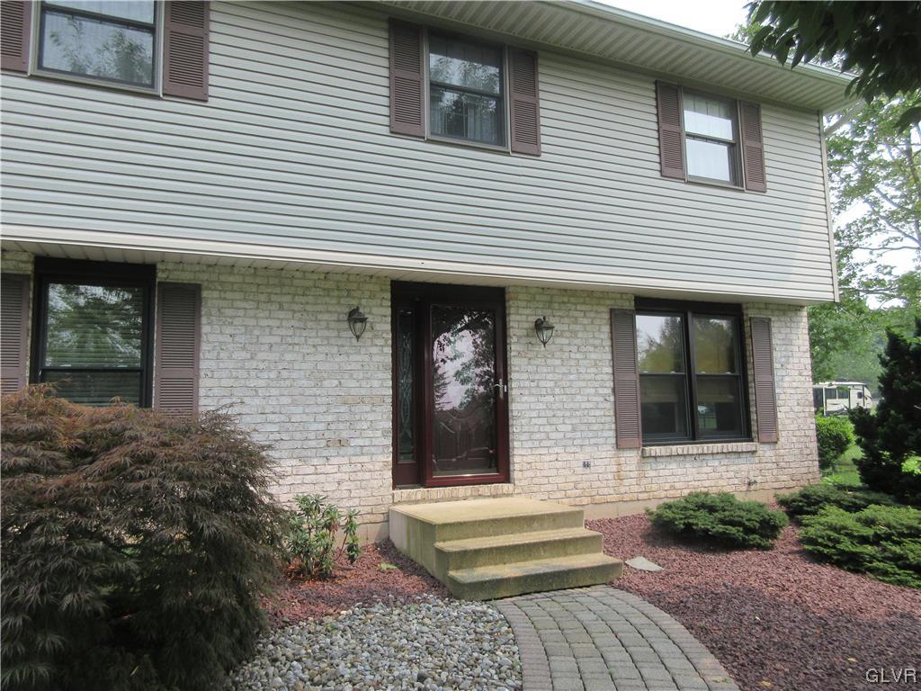 2139 Amlisa Road Nazareth, PA 18064 - Photo 13 of 35 a view of a white house with large windows and a flower plants