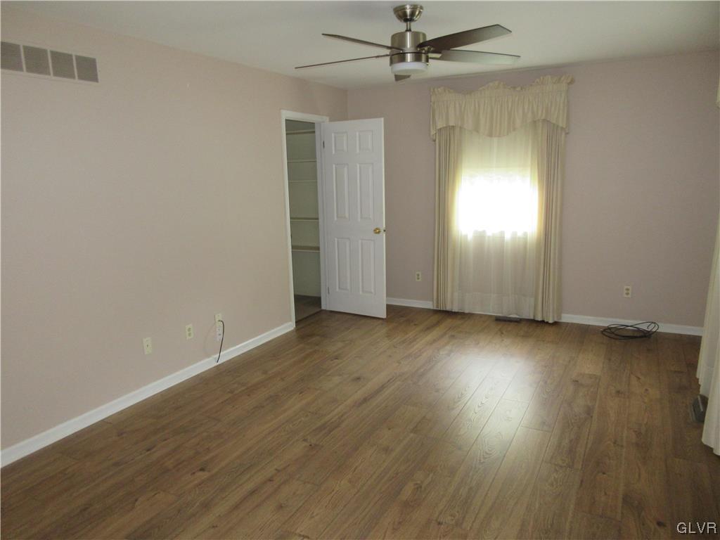 2139 Amlisa Road Nazareth, PA 18064 - Photo 24 of 35 an empty room with wooden floor ceiling fan and windows