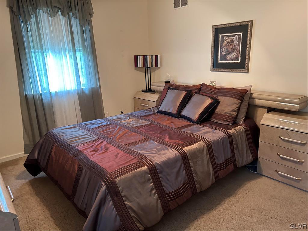 2139 Amlisa Road Nazareth, PA 18064 - Photo 28 of 35 a bedroom with a bed and a chandelier