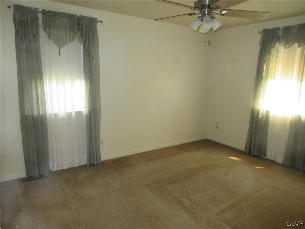 2139 Amlisa Road Nazareth, PA 18064 - Photo 30 of 35 an empty room with a chandelier fan and windows