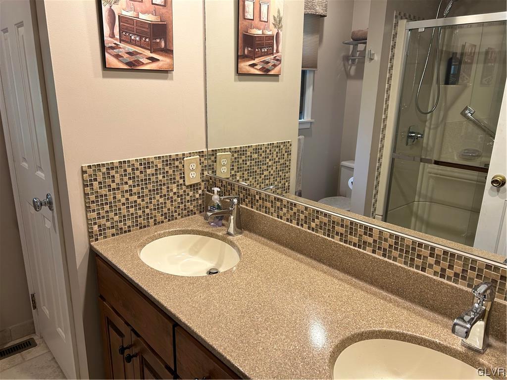 2139 Amlisa Road Nazareth, PA 18064 - Photo 32 of 35 a bathroom with a granite countertop double vanity sink and mirror