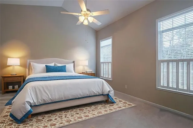 a bedroom with a bed chandelier and a window