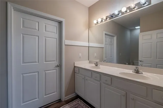 a bathroom with a double vanity sink and mirror