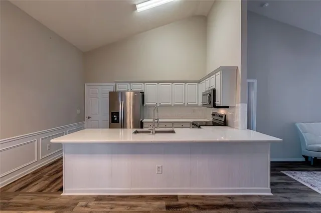 a room with kitchen countertops and wooden floor