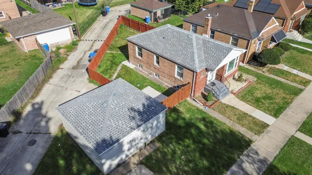 an aerial view of houses with backyard