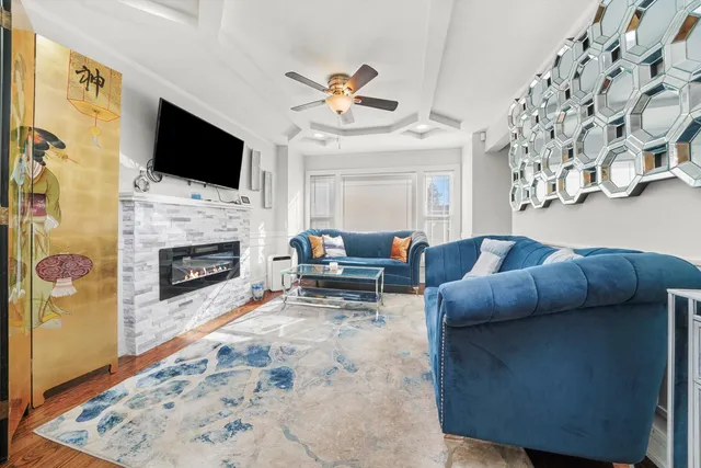 a living room with furniture a flat screen tv and a fireplace