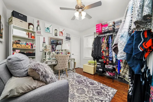 a living room with lots of furniture and clothes