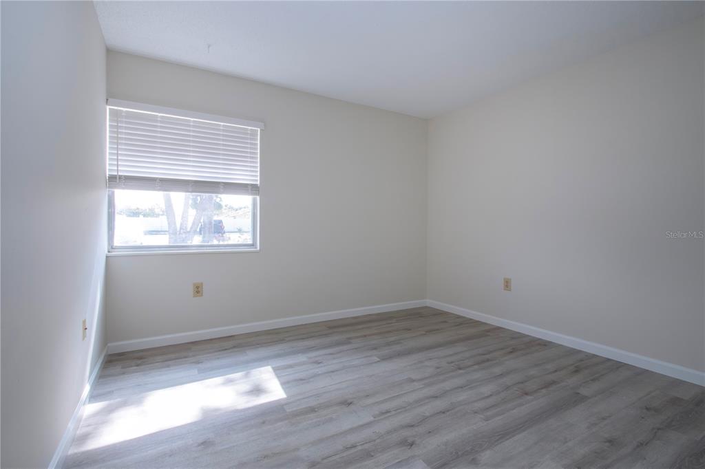 3259 South Beneva Road, Unit 102 Sarasota, FL 34232 - Photo 17 of 38 a view of a room with wooden floor and window