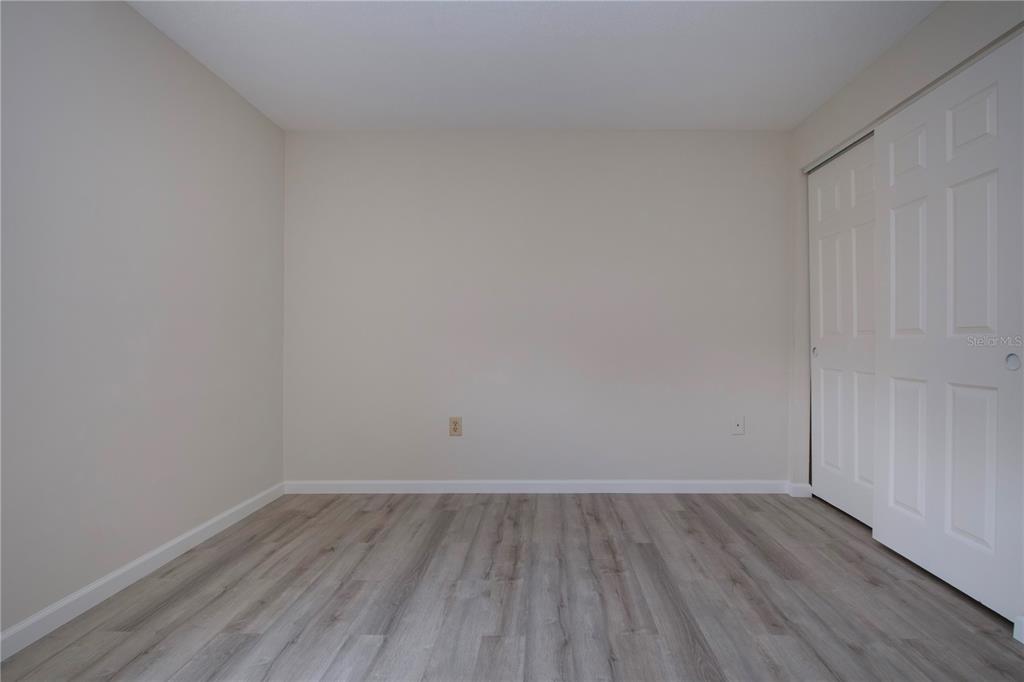 3259 South Beneva Road, Unit 102 Sarasota, FL 34232 - Photo 18 of 38 a view of an empty room and wooden floor