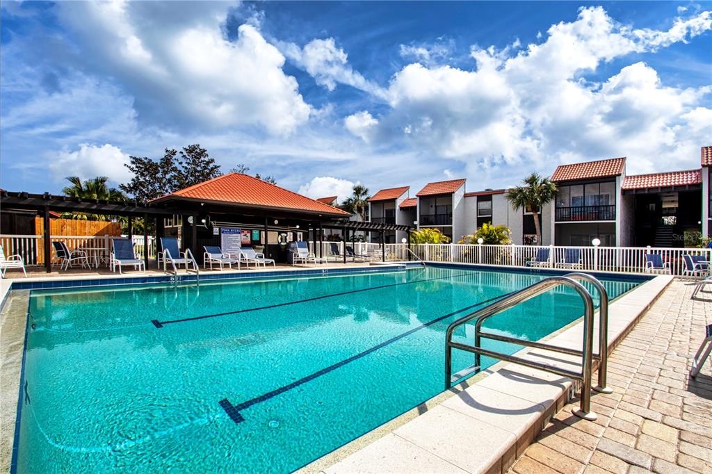 3259 South Beneva Road, Unit 102 Sarasota, FL 34232 - Photo 35 of 38 a swimming pool with outdoor seating and yard