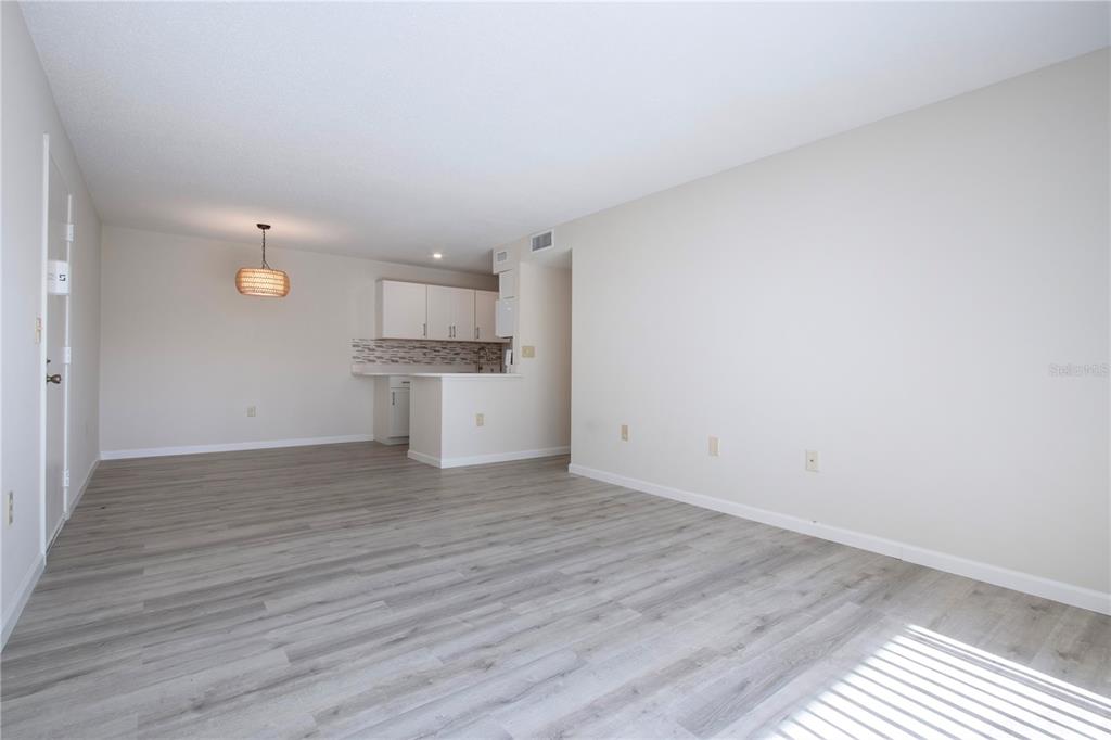 3259 South Beneva Road, Unit 102 Sarasota, FL 34232 - Photo 6 of 38 a view of a kitchen with a sink and wooden floor