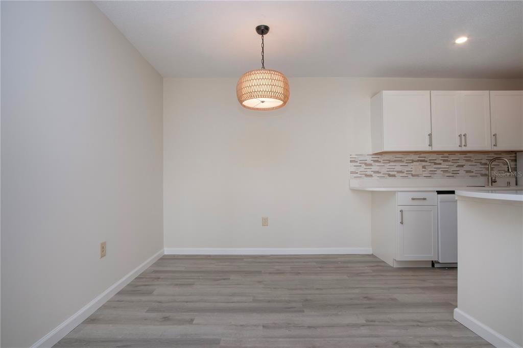 3259 South Beneva Road, Unit 102 Sarasota, FL 34232 - Photo 8 of 38 a view of a room with wooden floor and white walls