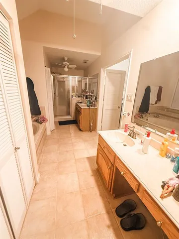 a bathroom with a sink a mirror and shower