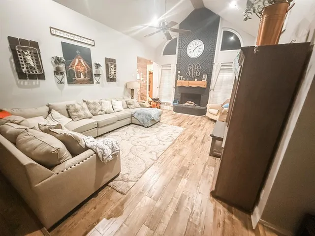 a living room with furniture and a large mirror
