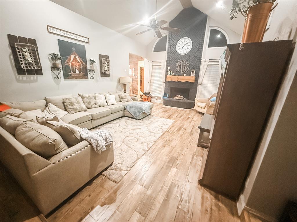 6102 Tacoma Street Rowlett, TX 75089 - Photo 8 of 16 a living room with furniture and a large mirror