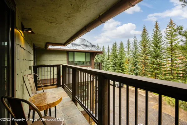 a view of a balcony with furniture