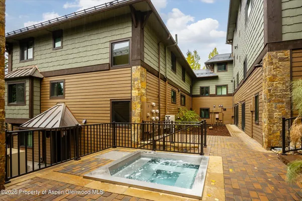 a view of a brick house with large windows