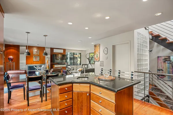 a kitchen with granite countertop a sink and cabinets