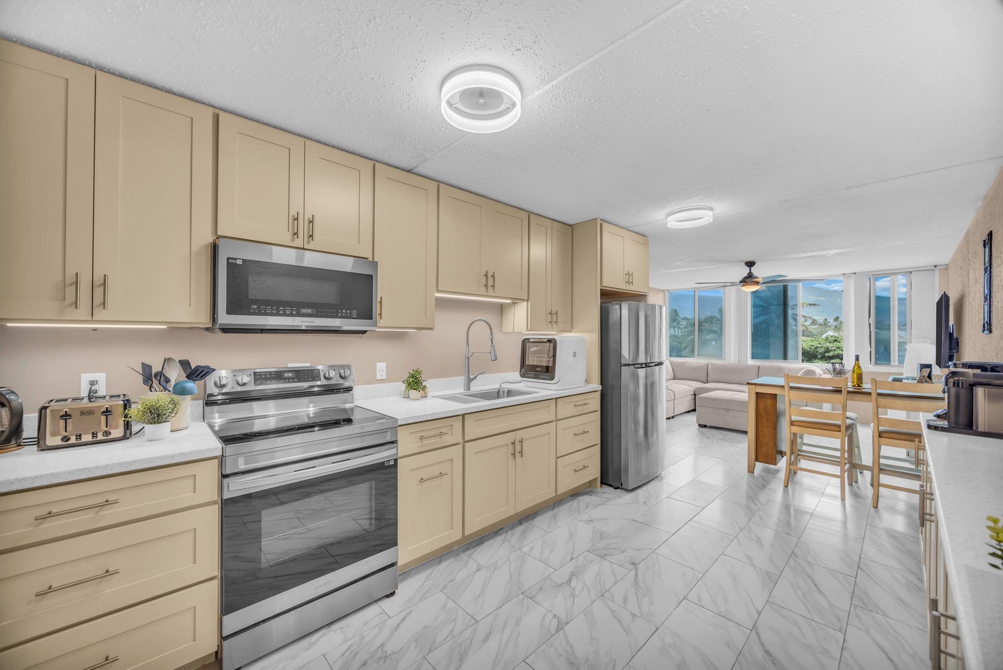 111 Kahului Beach Road, Unit D402 Kahului, HI 96732 - Photo 3 of 27 a kitchen with a sink stove and cabinets