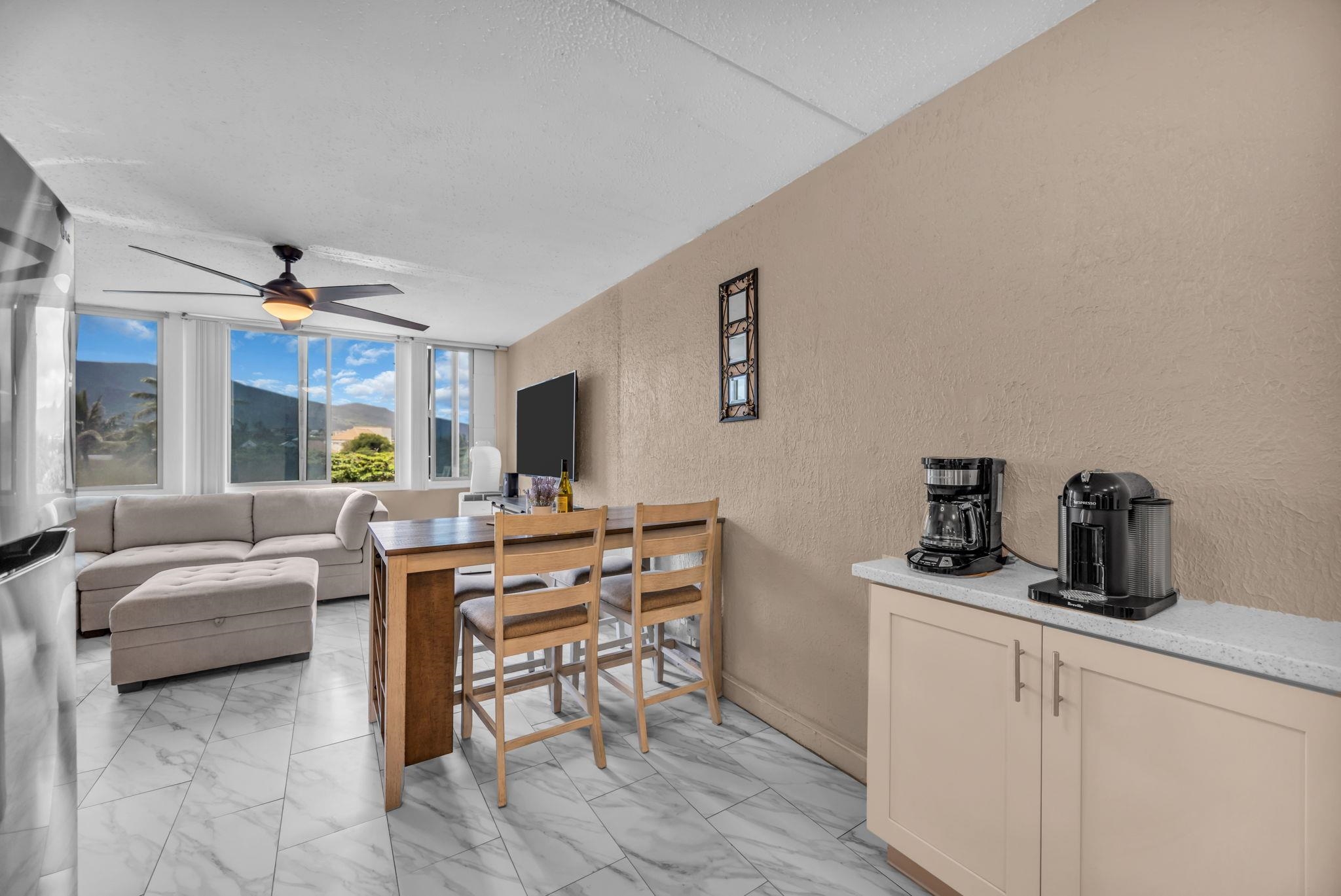 111 Kahului Beach Road, Unit D402 Kahului, HI 96732 - Photo 4 of 27 a living room with furniture and a flat screen tv