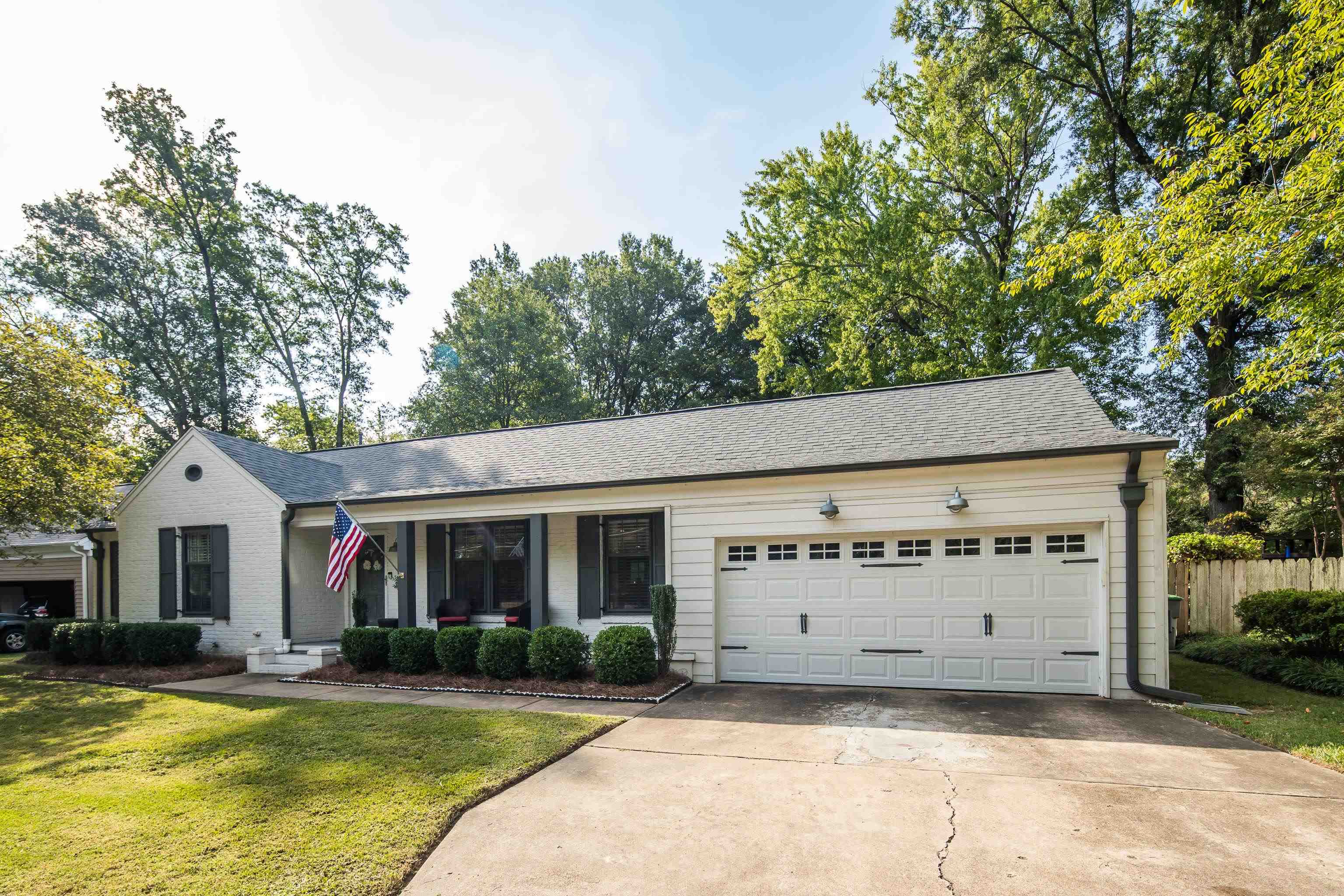 5271 Mason Road Memphis, TN 38120 - Photo 2 of 25 a view of a white house with a big yard and large trees