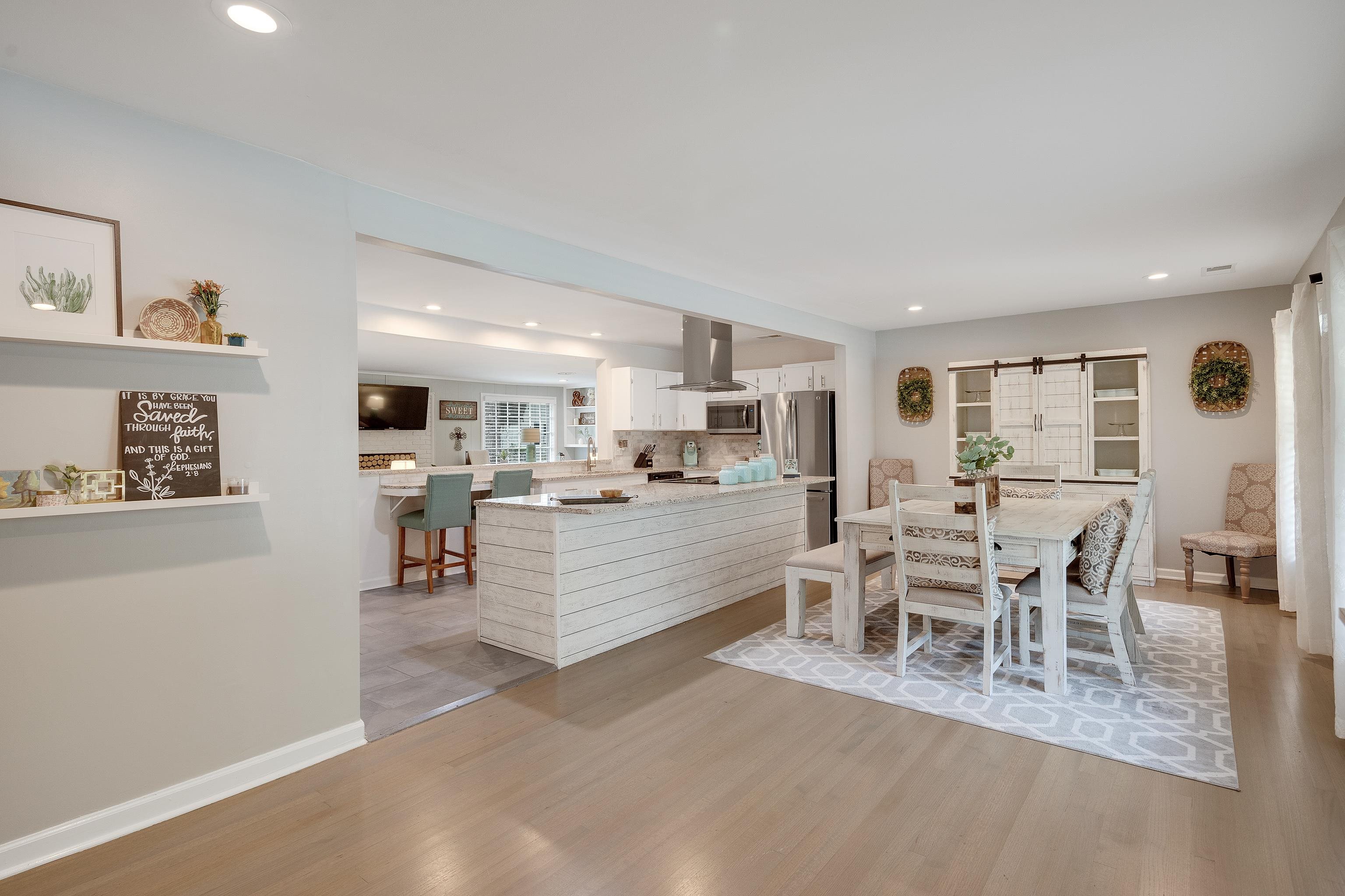 5271 Mason Road Memphis, TN 38120 - Photo 5 of 25 a large white kitchen with lots of counter space and dining table