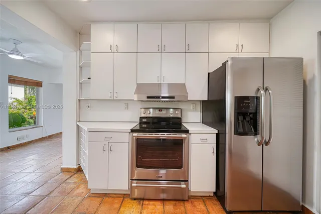 a kitchen with a stove and a refrigerator