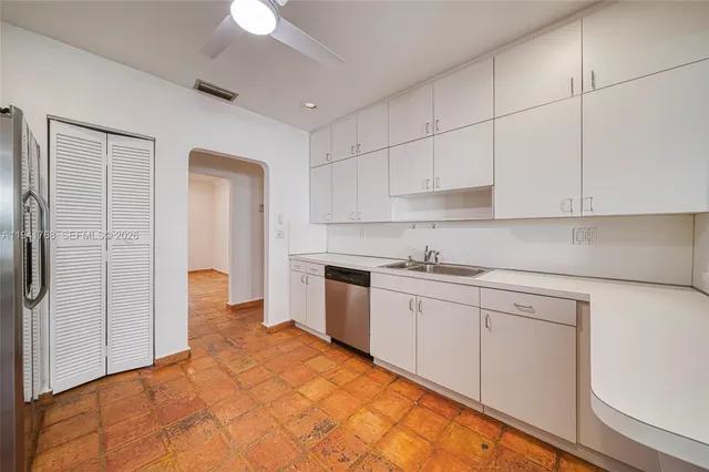 a kitchen with a sink cabinets and appliances