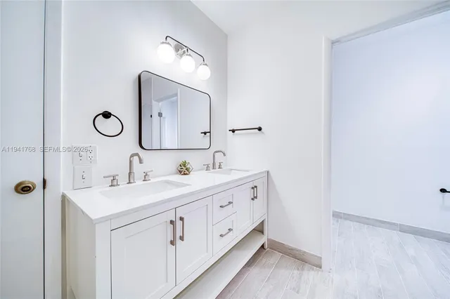 a bathroom with a double vanity sink and mirror
