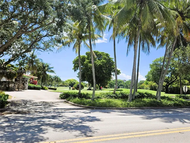 a backyard of a house with a yard and outdoor seating