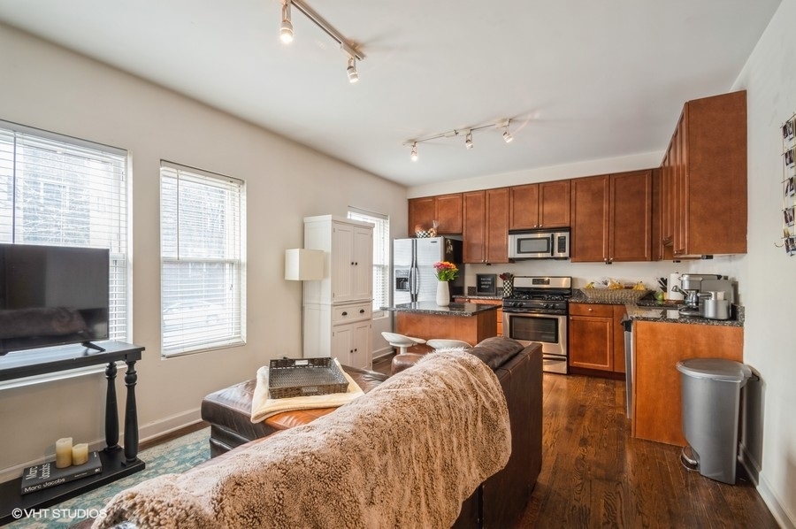 Undisclosed Address Chicago, IL 60657 - Photo 3 of 10 a living room with stainless steel appliances furniture and a flat screen tv