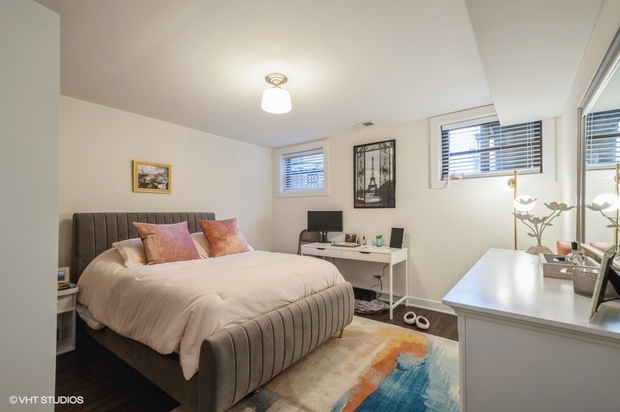 Undisclosed Address Chicago, IL 60657 - Photo 4 of 10 a bedroom with a bed and a table in it