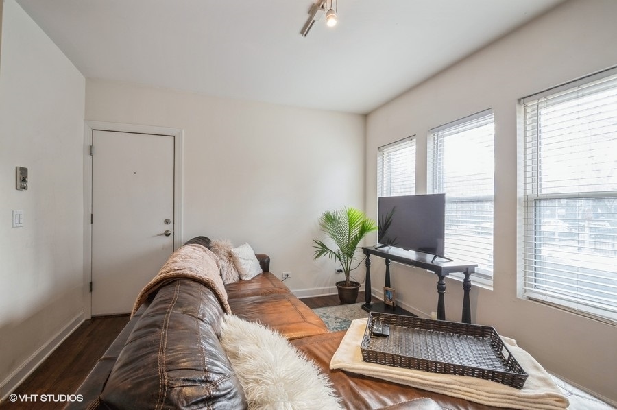 Undisclosed Address Chicago, IL 60657 - Photo 7 of 10 a living room with furniture and a flat screen tv