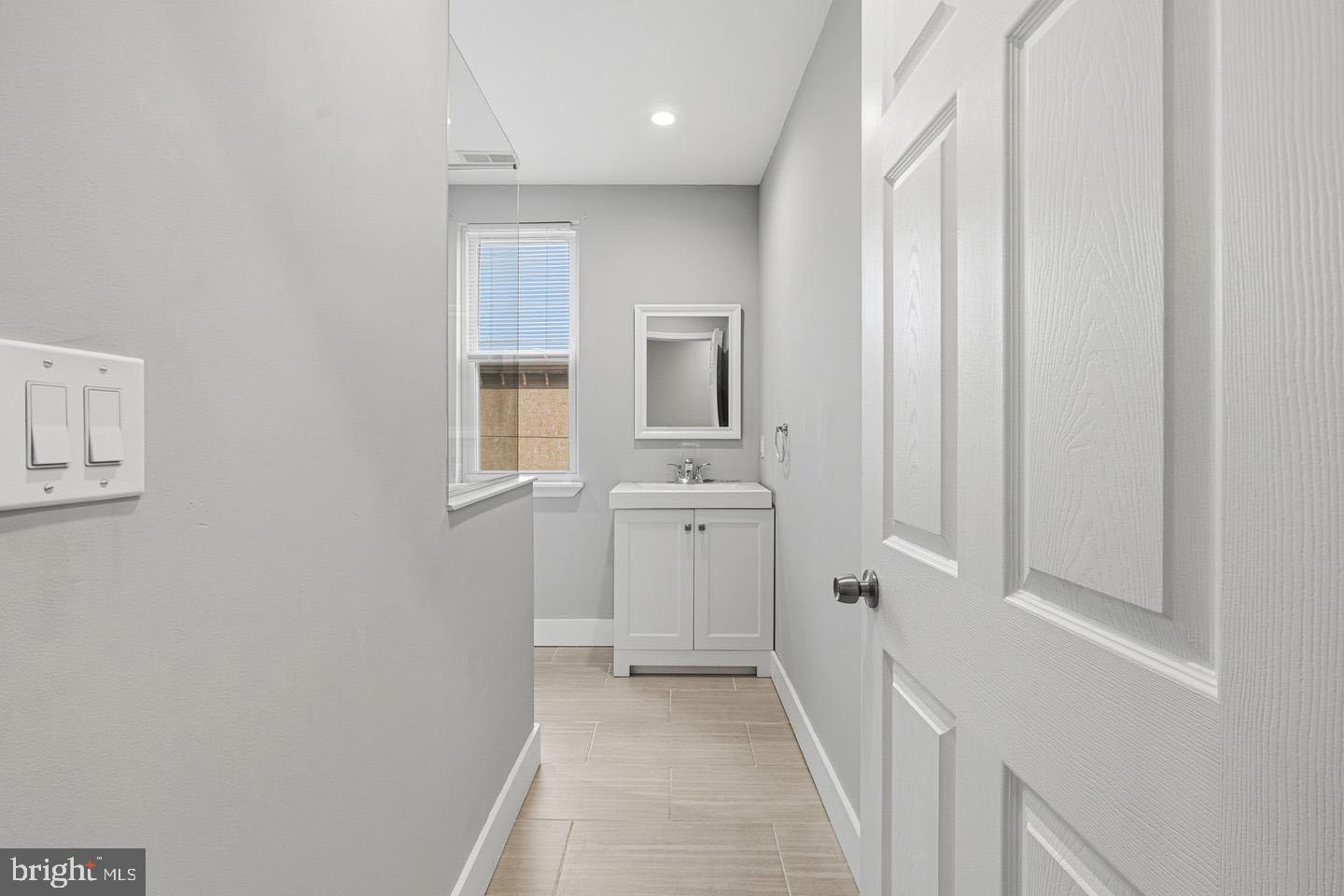 2106 Manton Street Philadelphia, PA 19146 - Photo 14 of 34 a bathroom with a sink a toilet and a mirror