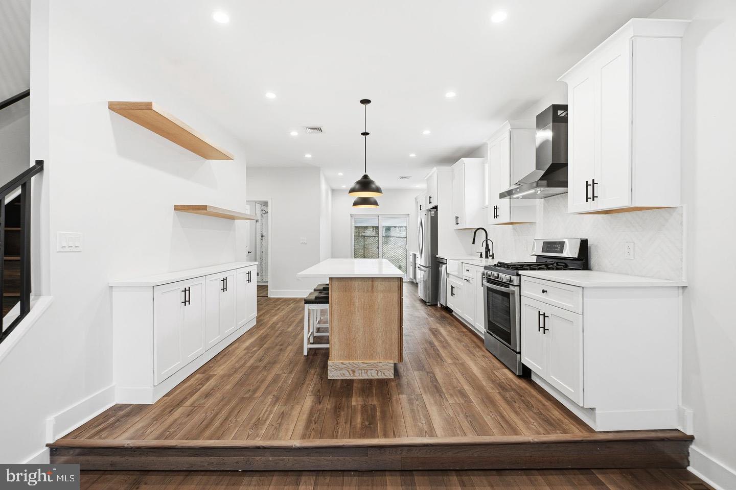 2106 Manton Street Philadelphia, PA 19146 - Photo 2 of 34 a kitchen with granite countertop white cabinets and stainless steel appliances