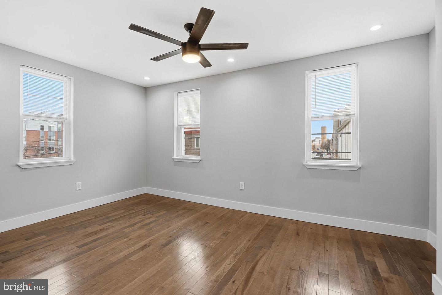 2106 Manton Street Philadelphia, PA 19146 - Photo 22 of 34 a view of a big room with wooden floor and a ceiling fan