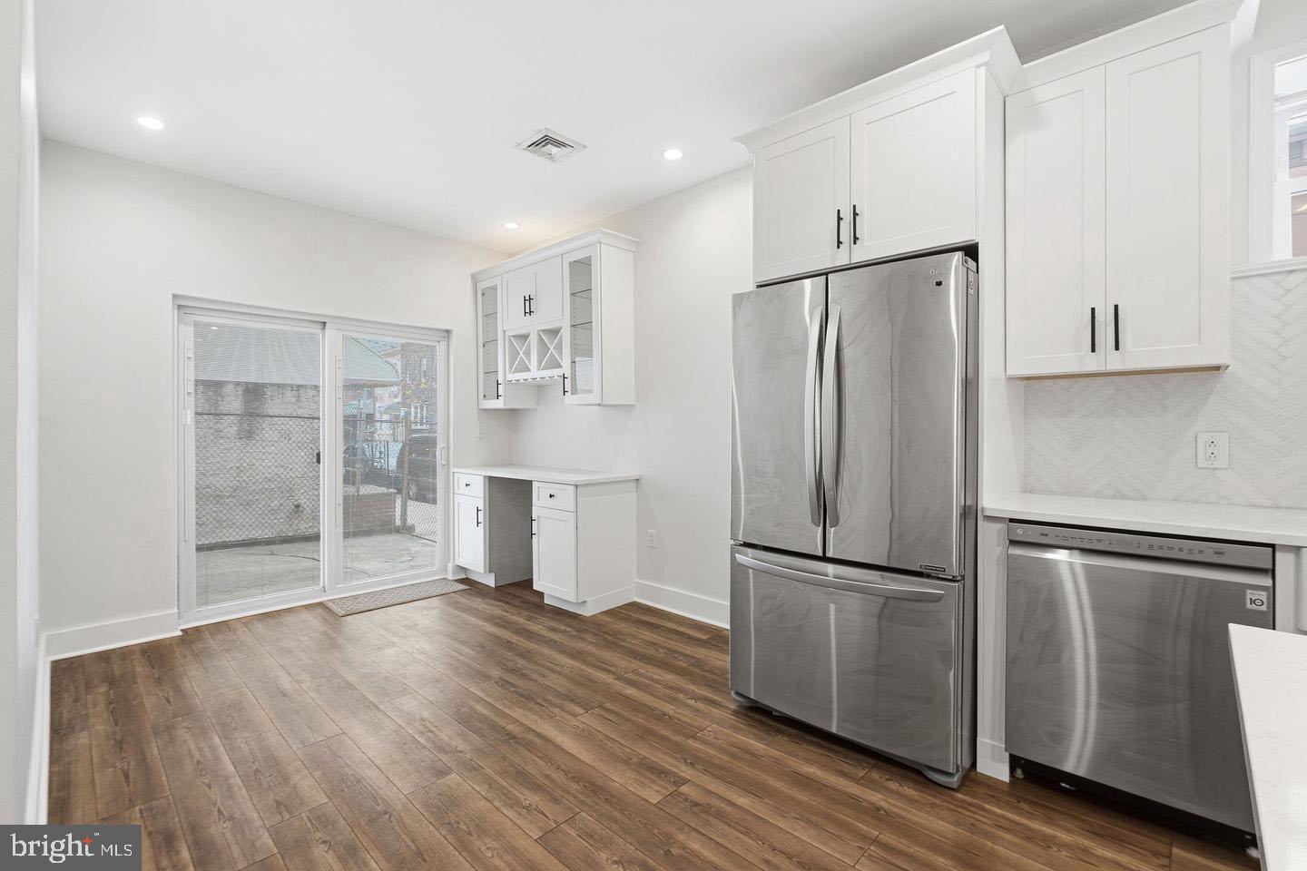 2106 Manton Street Philadelphia, PA 19146 - Photo 7 of 34 a metallic refrigerator freezer sitting in a kitchen