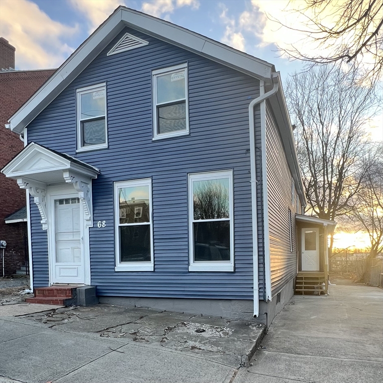 a view of brick house with large windows