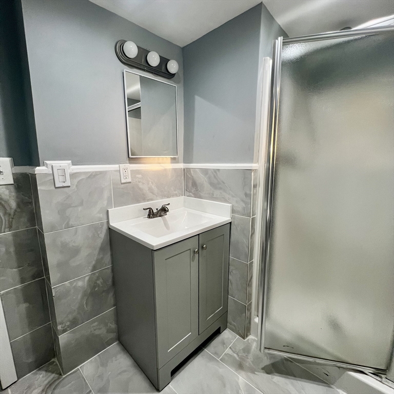 68 Springfield Street Chicopee, MA 01013 - Photo 12 of 41 a bathroom with a sink and mirror