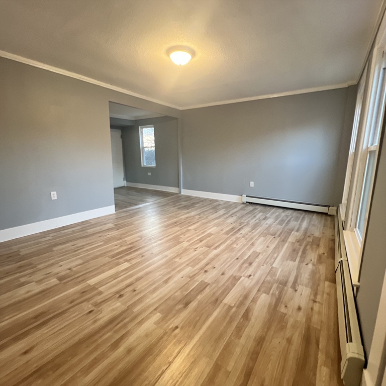 68 Springfield Street Chicopee, MA 01013 - Photo 18 of 41 an empty room with wooden floor and windows