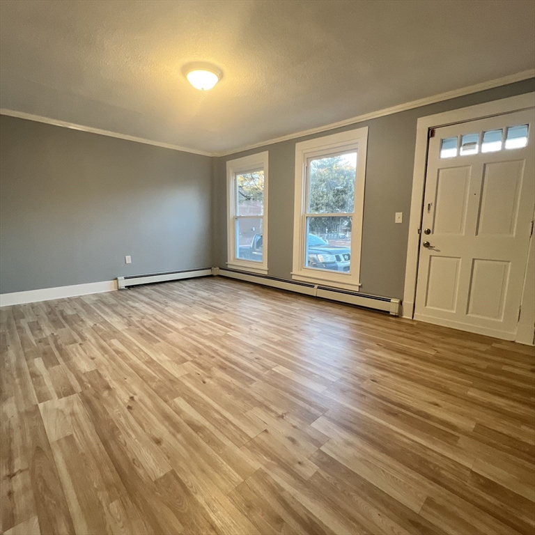 68 Springfield Street Chicopee, MA 01013 - Photo 19 of 41 a view of an empty room with wooden floor and a window