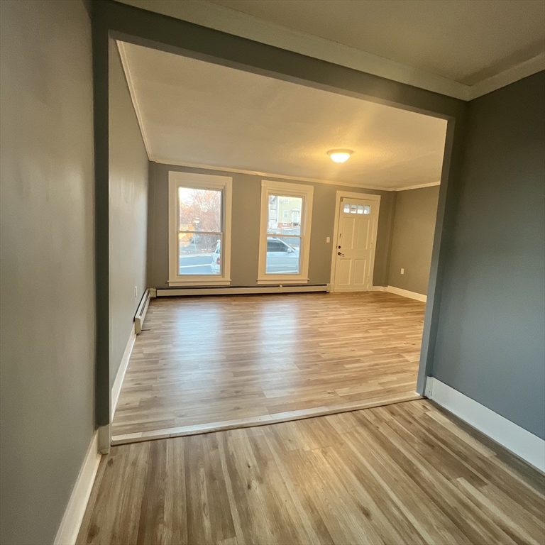 68 Springfield Street Chicopee, MA 01013 - Photo 20 of 41 a view of an empty room with wooden floor and a window