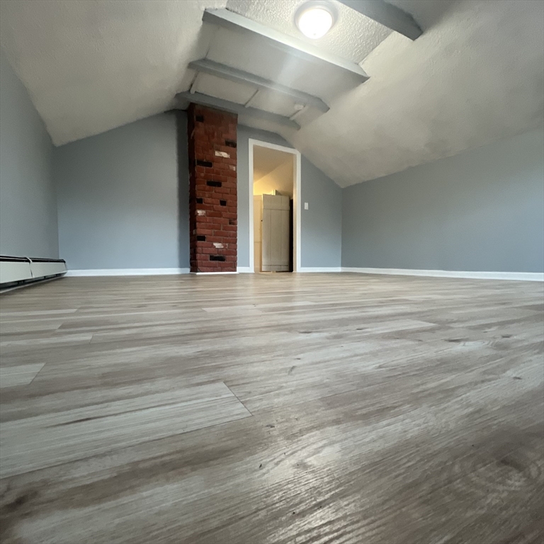 68 Springfield Street Chicopee, MA 01013 - Photo 23 of 41 a view of an empty room with window and wooden floor