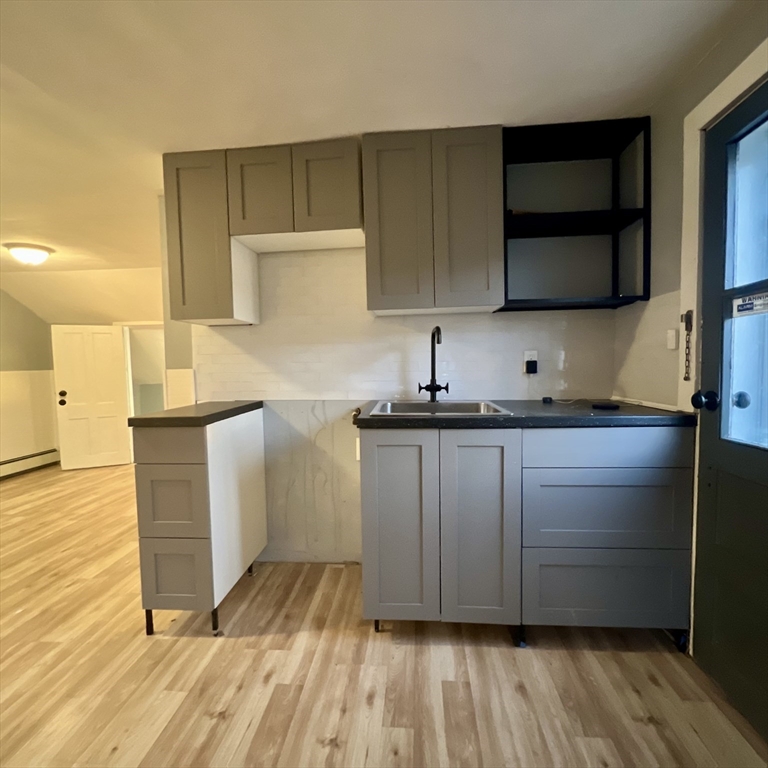 68 Springfield Street Chicopee, MA 01013 - Photo 26 of 41 a kitchen with a sink a stove and cabinets