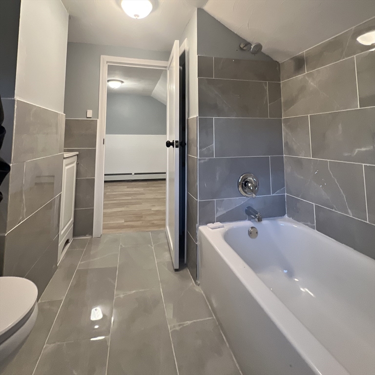 68 Springfield Street Chicopee, MA 01013 - Photo 31 of 41 a bathroom with a tub a toilet and a shower