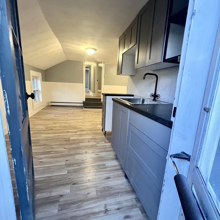68 Springfield Street Chicopee, MA 01013 - Photo 35 of 41 a kitchen with granite countertop wooden cabinets and a stove top oven