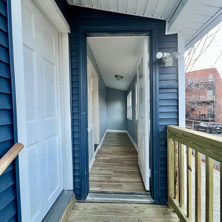 68 Springfield Street Chicopee, MA 01013 - Photo 7 of 41 a view of a hallway with wooden floor and staircase
