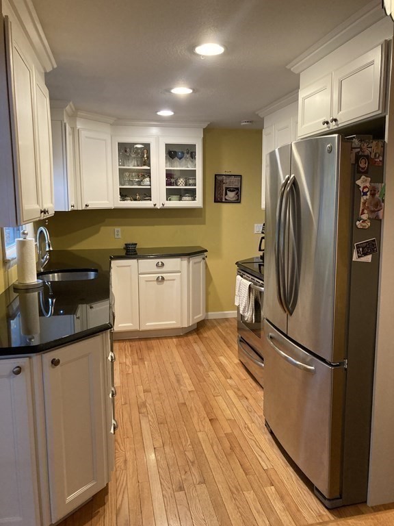 56 Ridge Road South Hadley, MA 01075 - Photo 13 of 37 a kitchen with a refrigerator sink and wooden floor
