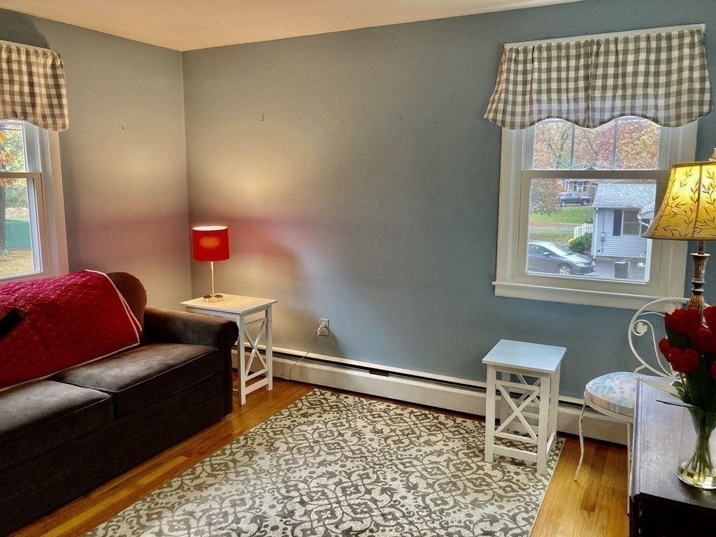 56 Ridge Road South Hadley, MA 01075 - Photo 19 of 37 a living room with a couch and a table with wooden floor